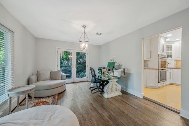 office featuring wood finished floors, a chandelier, baseboards, french doors, and recessed lighting