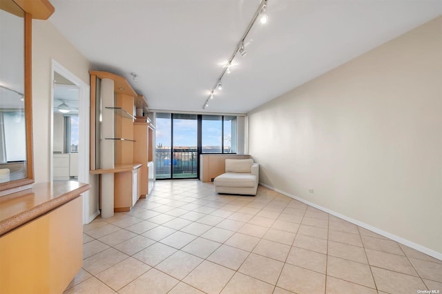 2 Bay Club Dr Unit 3Z3, Bayside, NY 11360 - unfurnished room featuring track lighting, light tile patterned floors, floor to ceiling windows, and baseboards