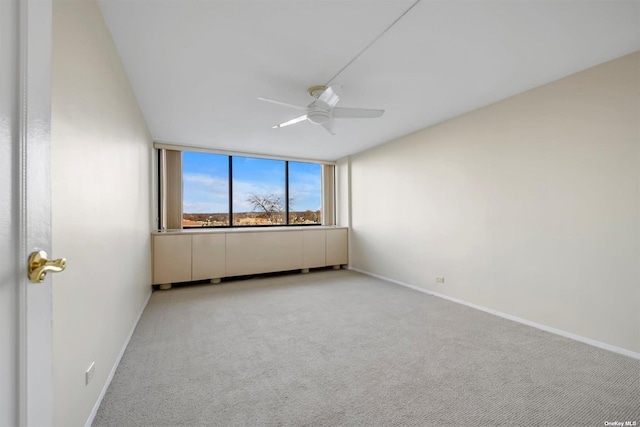 2 Bay Club Dr Unit 3Z3, Bayside, NY 11360 - spare room featuring a ceiling fan, light carpet, and baseboards