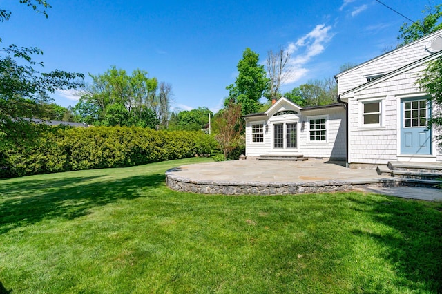 view of green lawn featuring a patio and entry steps