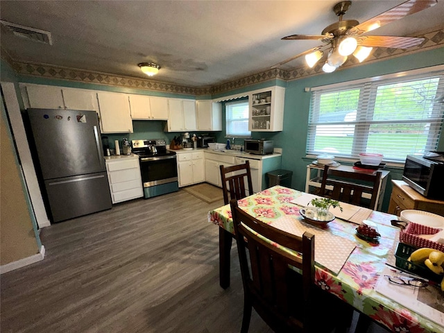 23 Hawkins Path, Coram, NY 11727 - kitchen with stainless steel appliances, dark wood-style floors, white cabinets, ceiling fan, and light countertops