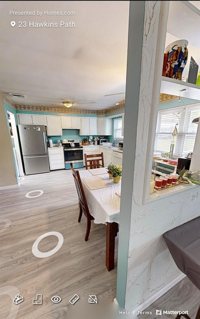 23 Hawkins Path, Coram, NY 11727 - dining space featuring light wood-style flooring
