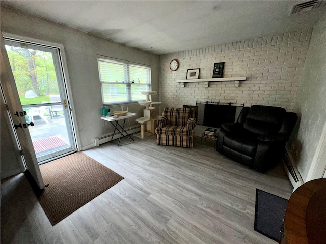 23 Hawkins Path, Coram, NY 11727 - living area featuring a baseboard radiator and wood finished floors