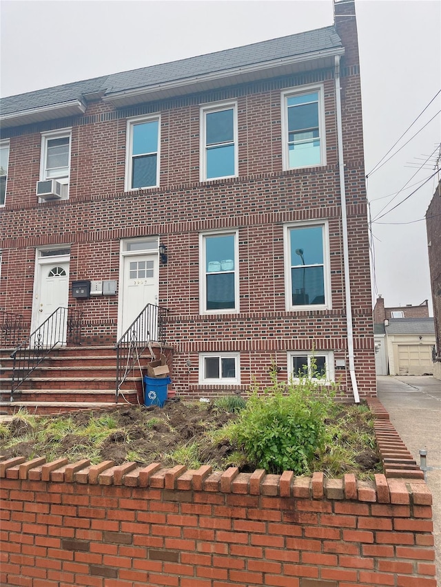 multi unit property with brick siding and cooling unit