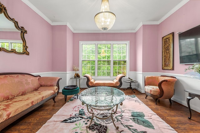 sitting room featuring healthy amount of natural light, a chandelier, crown molding, dark wood-style flooring, and wainscoting