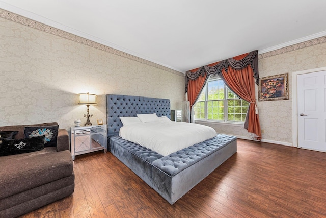 bedroom with wallpapered walls, crown molding, wood finished floors, and baseboards
