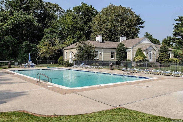 community pool featuring a patio area and fence