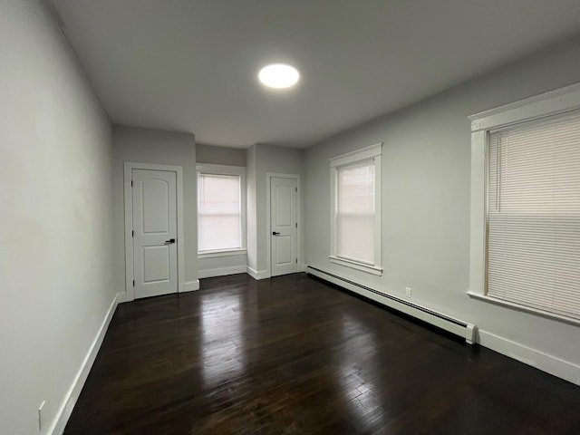 563 E 3rd St, Mount Vernon, NY 10553 - unfurnished room with a baseboard heating unit, baseboards, and dark wood-type flooring