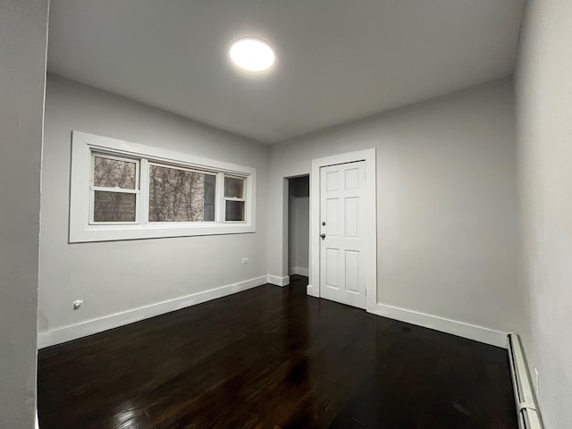 563 E 3rd St, Mount Vernon, NY 10553 - empty room featuring a baseboard radiator, baseboards, and dark wood-type flooring