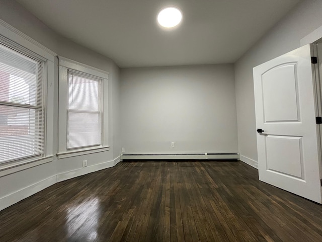 563 E 3rd St, Mount Vernon, NY 10553 - unfurnished room with baseboard heating, dark wood-style flooring, and baseboards