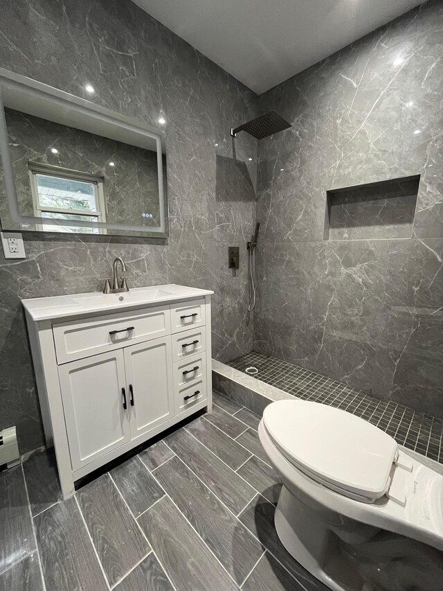 563 E 3rd St, Mount Vernon, NY 10553 - full bath with tile walls, tiled shower, vanity, and toilet