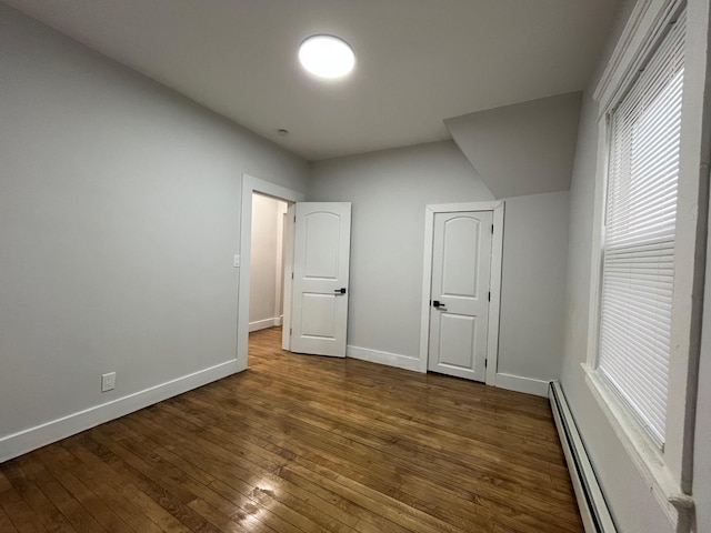 563 E 3rd St, Mount Vernon, NY 10553 - unfurnished bedroom featuring hardwood / wood-style floors, a baseboard heating unit, and baseboards