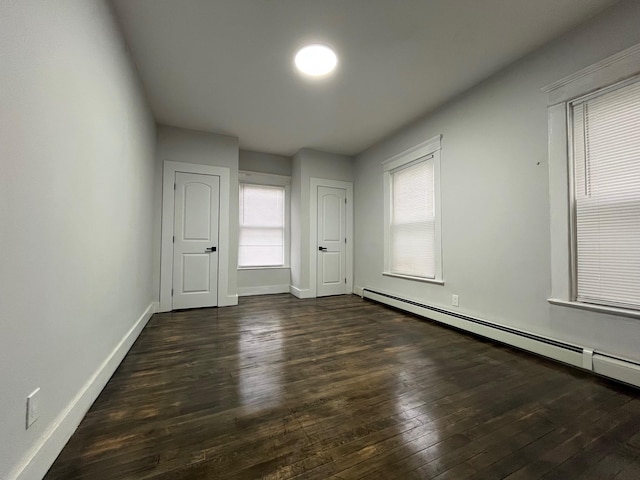 563 E 3rd St, Mount Vernon, NY 10553 - unfurnished room with a baseboard radiator, dark wood finished floors, and baseboards
