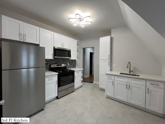 563 E 3rd St, Mount Vernon, NY 10553 - kitchen featuring appliances with stainless steel finishes, a sink, light countertops, tasteful backsplash, and white cabinetry