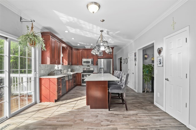 25 Crest Rd, Cold Spring, NY 10516 - kitchen with stainless steel appliances, crown molding, light countertops, backsplash, and a kitchen bar
