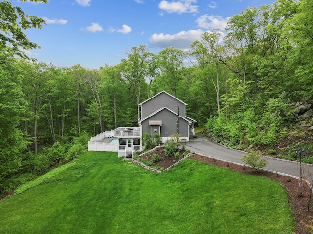 25 Crest Rd, Cold Spring, NY 10516 - view of front of home with a view of trees, an outdoor pool, a front lawn, and a wooden deck