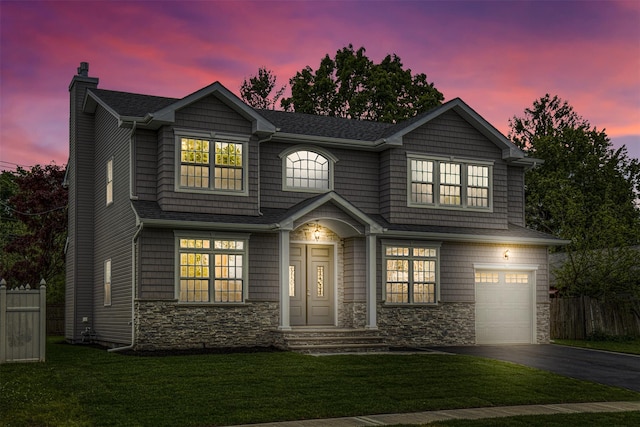 view of front of home with a chimney, stone siding, asphalt driveway, and a garage