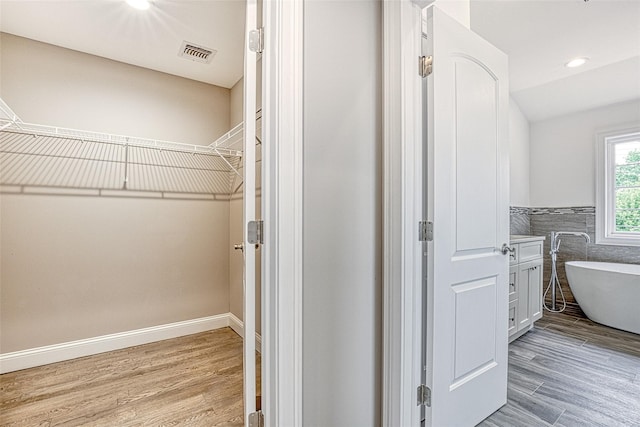 spacious closet featuring wood finished floors