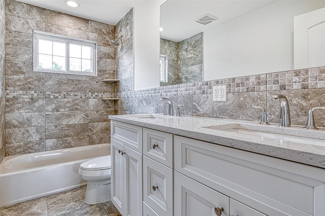 bathroom with toilet, tub / shower combination, tile walls, and double vanity