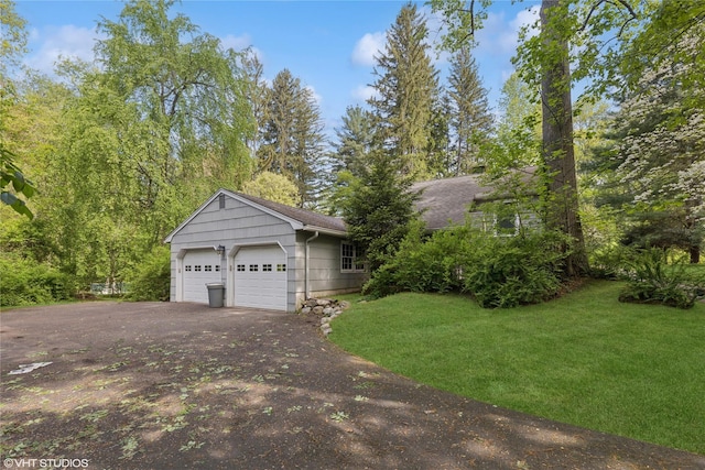 view of front facade with driveway, a front lawn, and a shingled roof