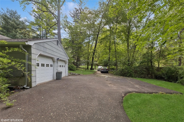 garage with asphalt driveway