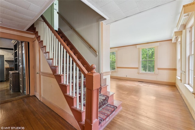 staircase with hardwood / wood-style flooring and baseboards