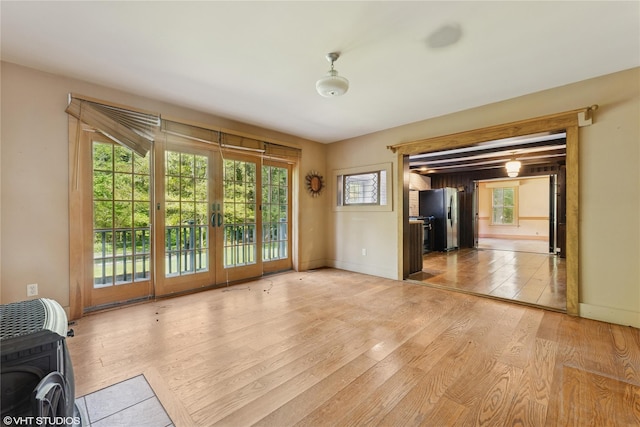 unfurnished room with light wood finished floors and baseboards