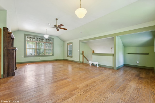 additional living space featuring ceiling fan, vaulted ceiling, wood finished floors, and baseboards