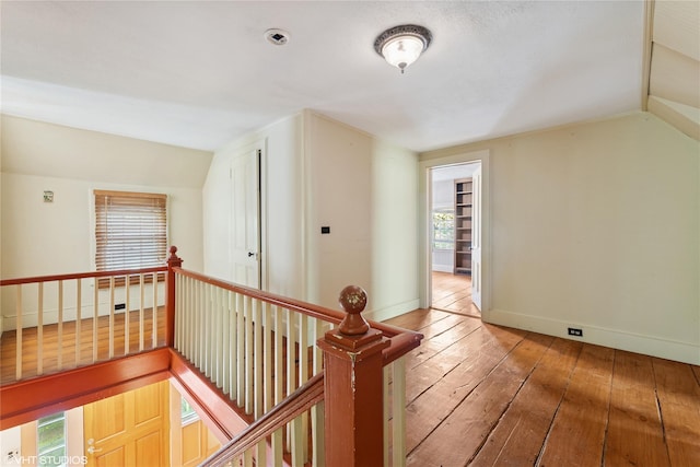 bonus room featuring light wood-type flooring, vaulted ceiling, and baseboards