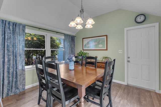 411 8th Ave, East Northport, NY 11731 - dining room featuring lofted ceiling, wood finished floors, and a chandelier