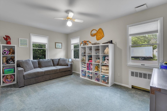 411 8th Ave, East Northport, NY 11731 - carpeted living room featuring radiator heating unit and ceiling fan