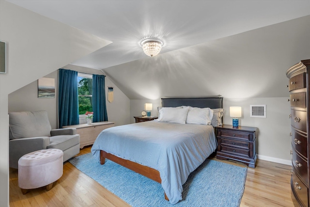 411 8th Ave, East Northport, NY 11731 - bedroom featuring light wood-style flooring and vaulted ceiling