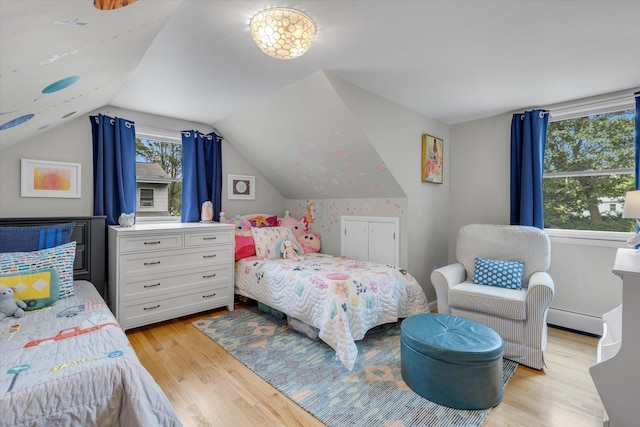 411 8th Ave, East Northport, NY 11731 - bedroom with light wood-style flooring, baseboard heating, and vaulted ceiling