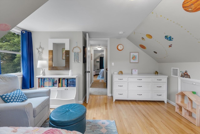 411 8th Ave, East Northport, NY 11731 - sitting room with light wood-style flooring and vaulted ceiling