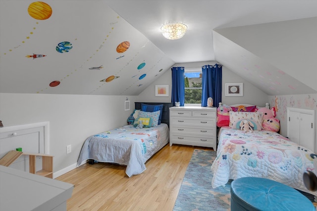 411 8th Ave, East Northport, NY 11731 - bedroom featuring light wood finished floors and vaulted ceiling