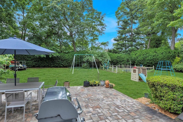 411 8th Ave, East Northport, NY 11731 - fenced backyard with a playground, a patio area, outdoor dining area, and view of wooded area