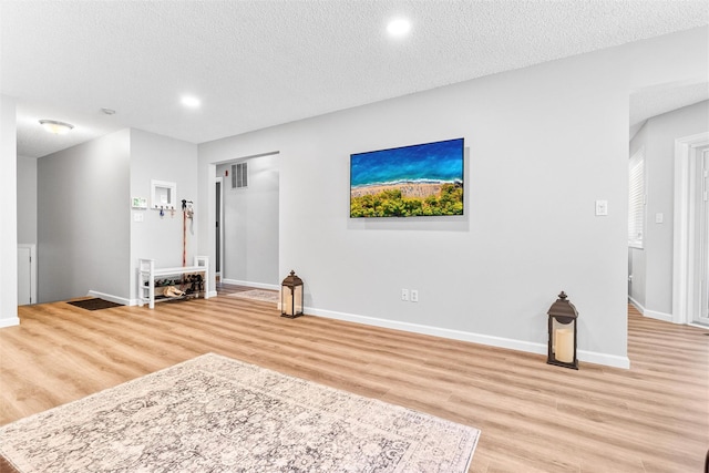 1 Mountain Ter, Nanuet, NY 10954 - unfurnished living room featuring light wood-type flooring, baseboards, a textured ceiling, and recessed lighting