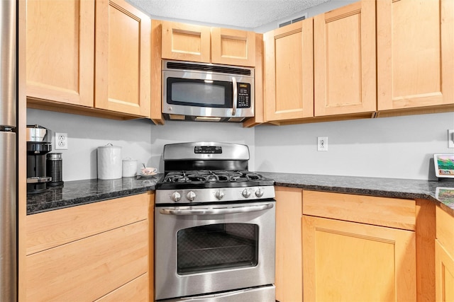 1 Mountain Ter, Nanuet, NY 10954 - kitchen with appliances with stainless steel finishes, light brown cabinets, a textured ceiling, and dark stone countertops