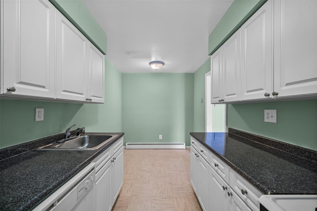 laundry area with a sink, a baseboard radiator, and baseboards
