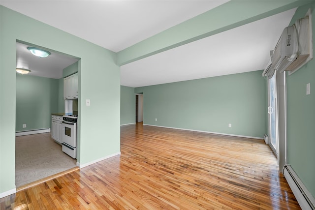 unfurnished living room featuring a baseboard radiator, light wood finished floors, a wall mounted air conditioner, and baseboards