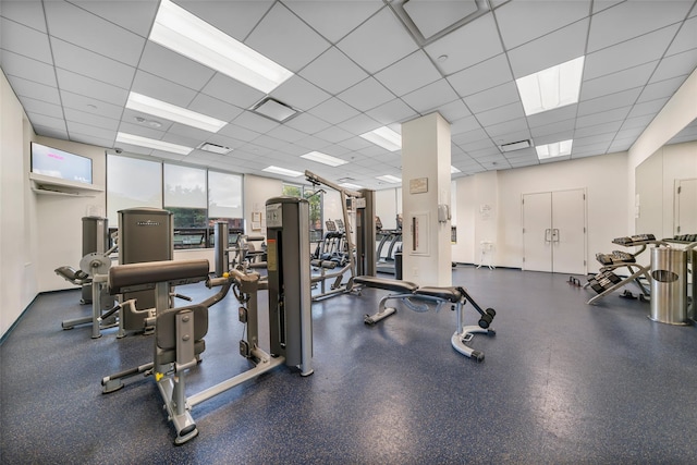 exercise room with a paneled ceiling
