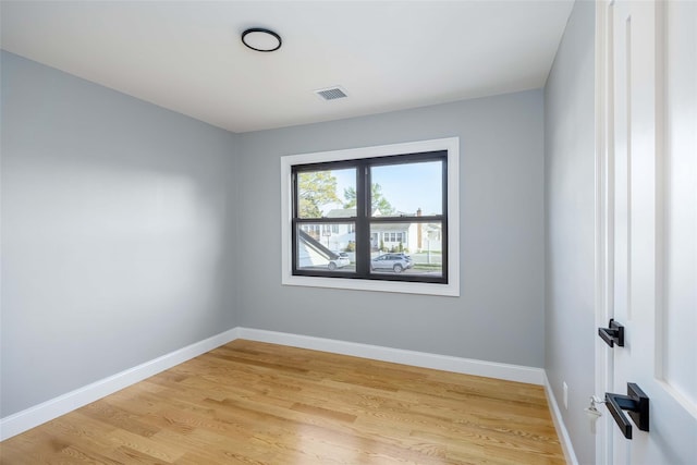 empty room with light wood-style flooring and baseboards