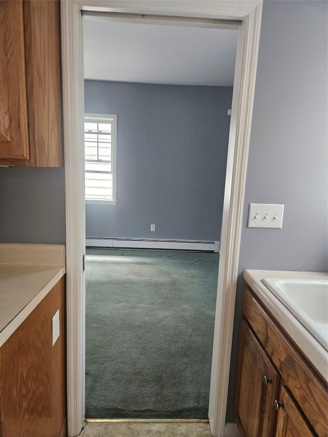 bathroom with vanity, a baseboard radiator, and baseboards