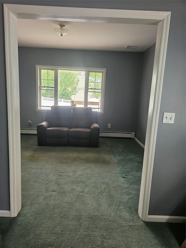 living area featuring dark colored carpet, healthy amount of natural light, a baseboard radiator, and baseboards