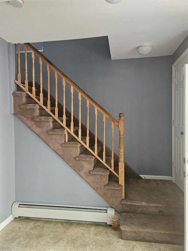stairway with baseboard heating and baseboards