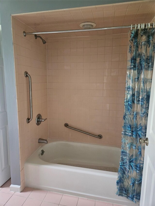 bathroom with shower / bath combo and tile patterned flooring