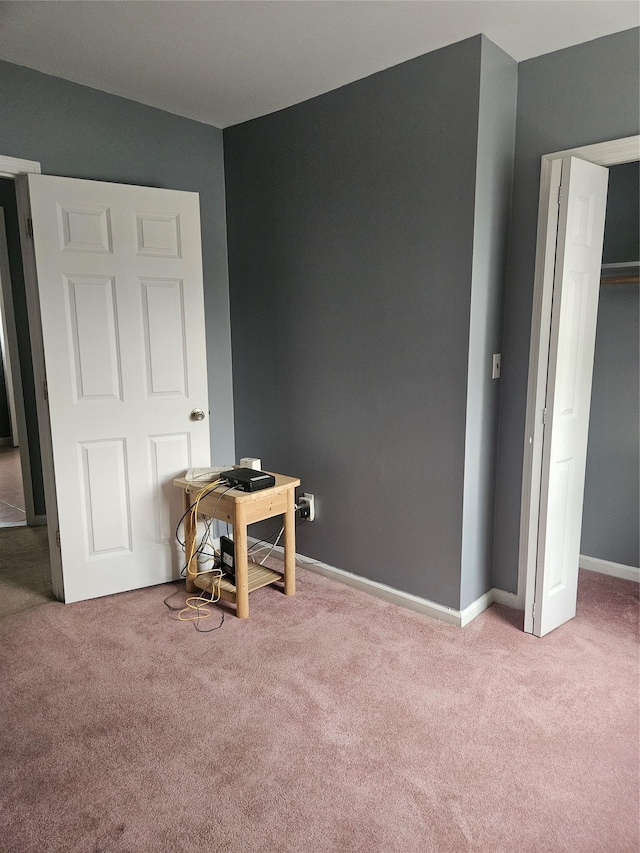 bedroom featuring carpet, baseboards, and a desk