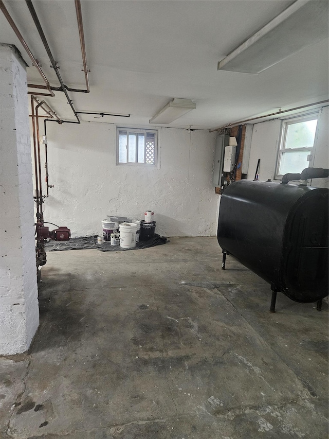 basement featuring oil tank and plenty of natural light