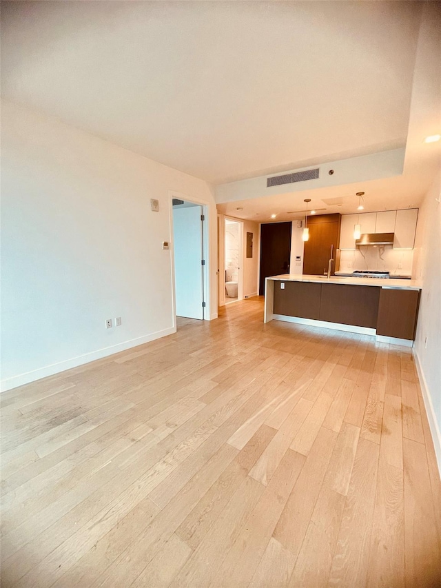 134-37 35th Ave Unit 8E, Flushing, NY 11354 - unfurnished living room with light wood-style floors, baseboards, recessed lighting, and a sink