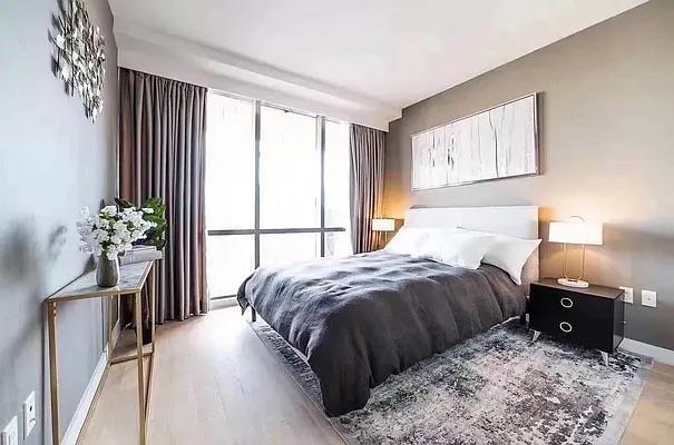 134-37 35th Ave Unit 8E, Flushing, NY 11354 - bedroom featuring baseboards and wood finished floors